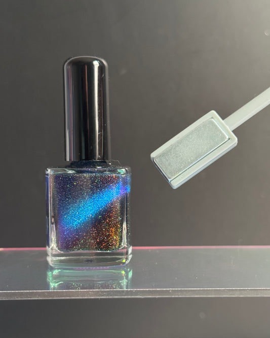 Rectangle end of magnetic wand pulls magnetic pigments into a line.