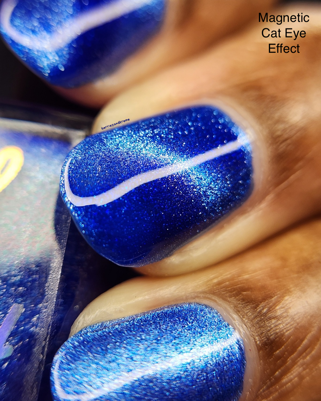 Blue nail polish with a silvery magnetic line.